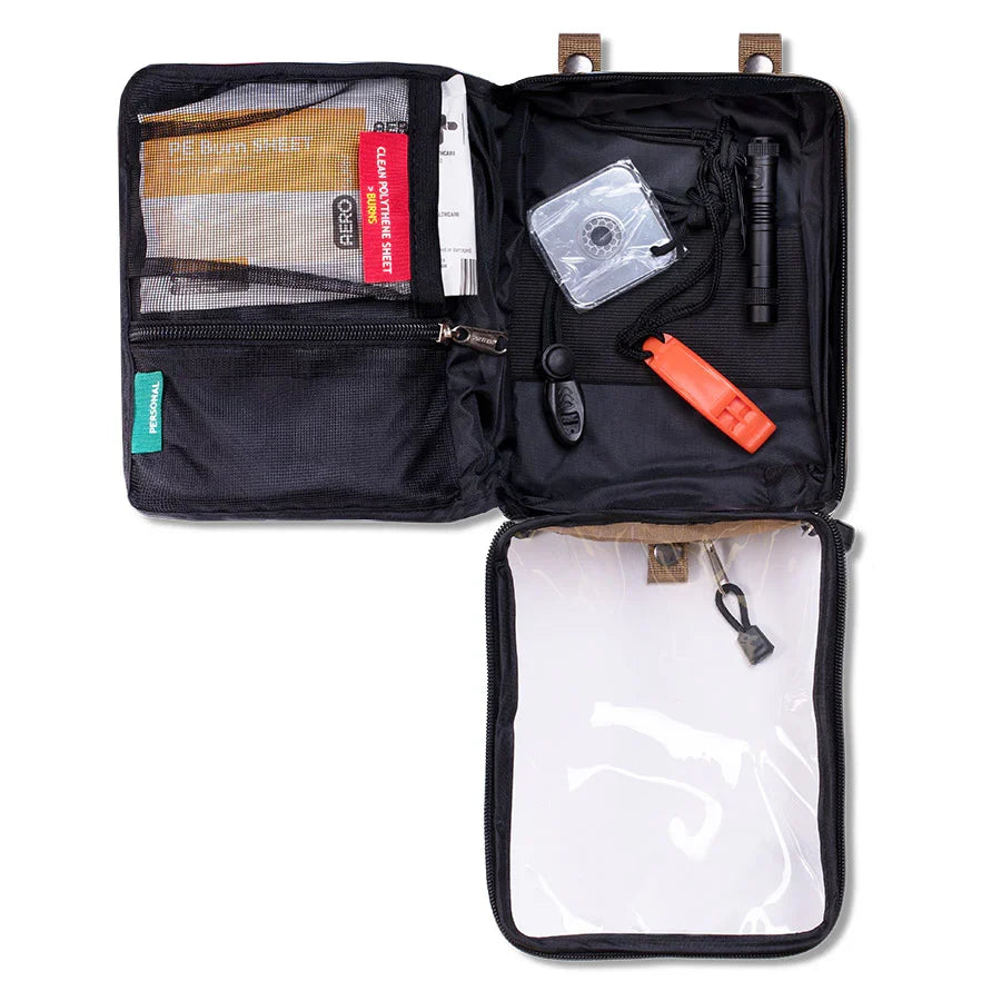 Module opened, showing the signal mirror, whistle and emergency blanket