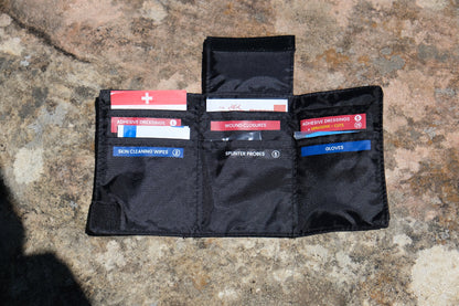 Opened Wallet 2.0 lying on a rock