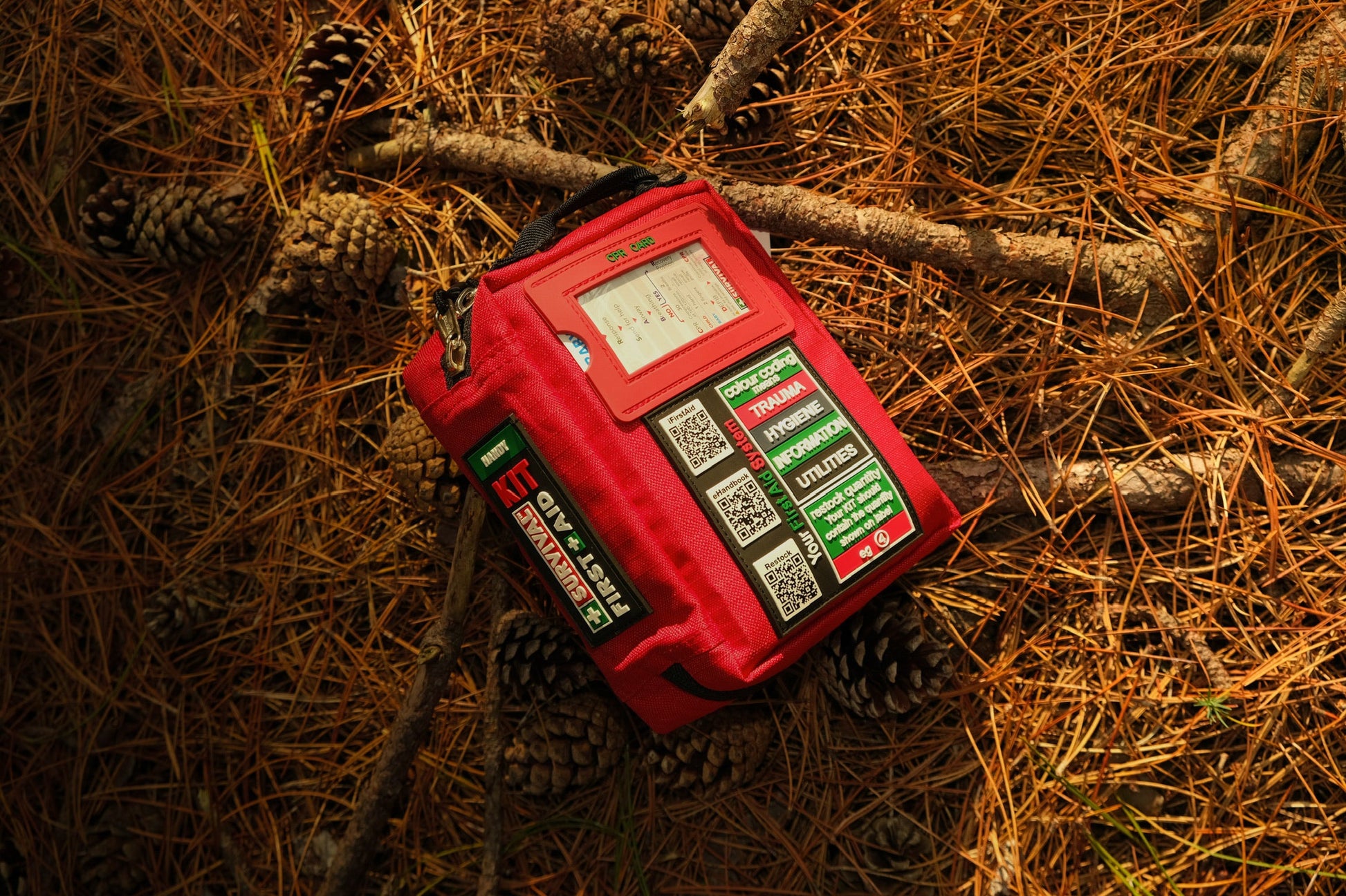 Red Handy case on a forest floor covered with pine needles