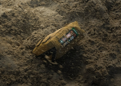 Coyote Hiking kit half buried in sand