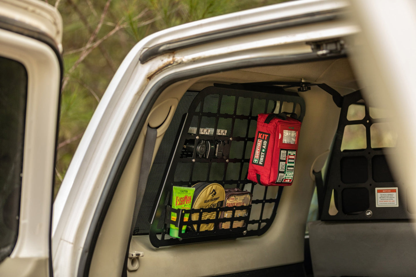 Red Handy case stored in a cargo net in the back of a vehicle
