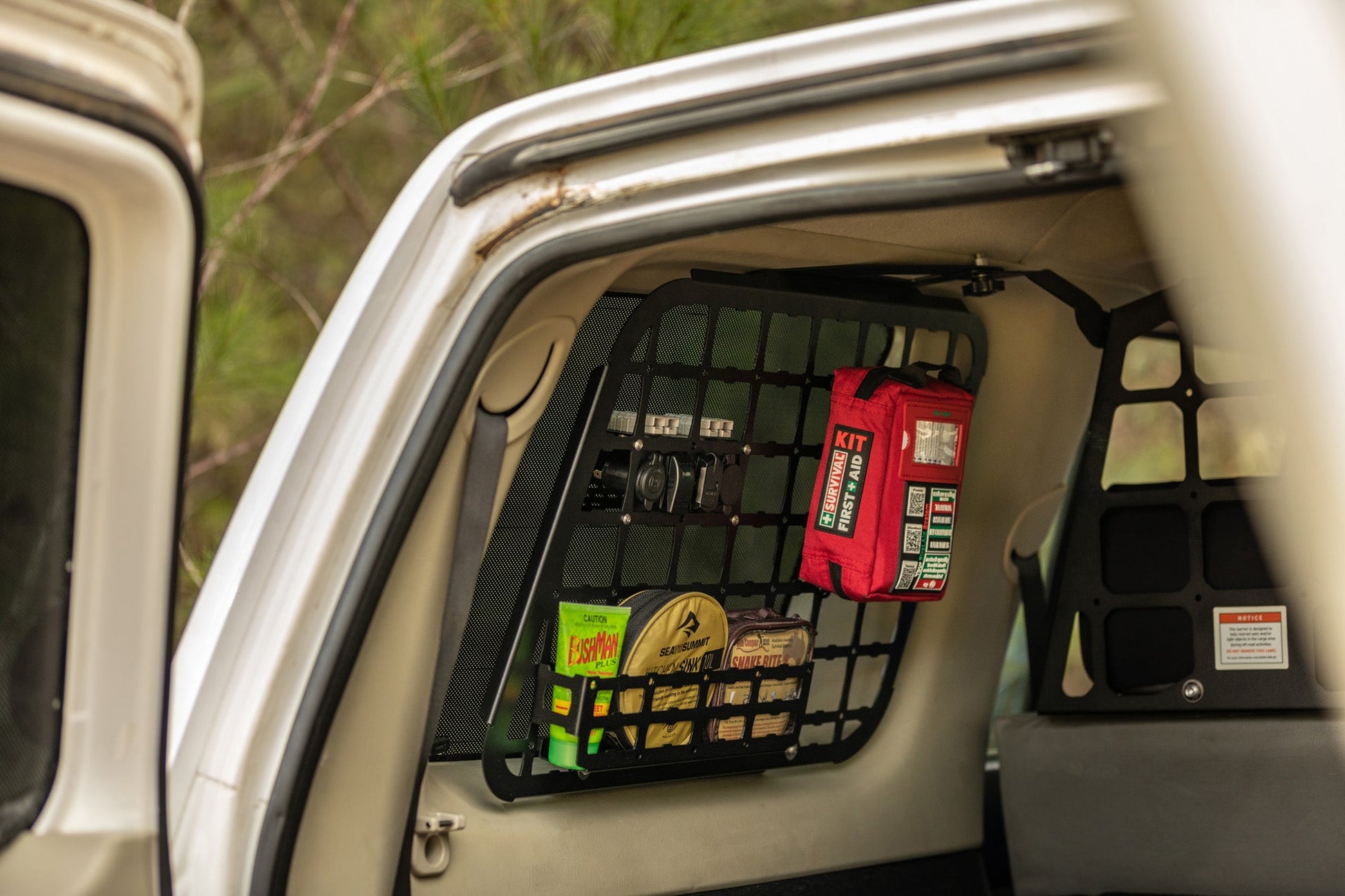 Red Handy case stored in a cargo net in the back of a vehicle