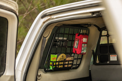 Red Handy case stored in a cargo net in the back of a vehicle