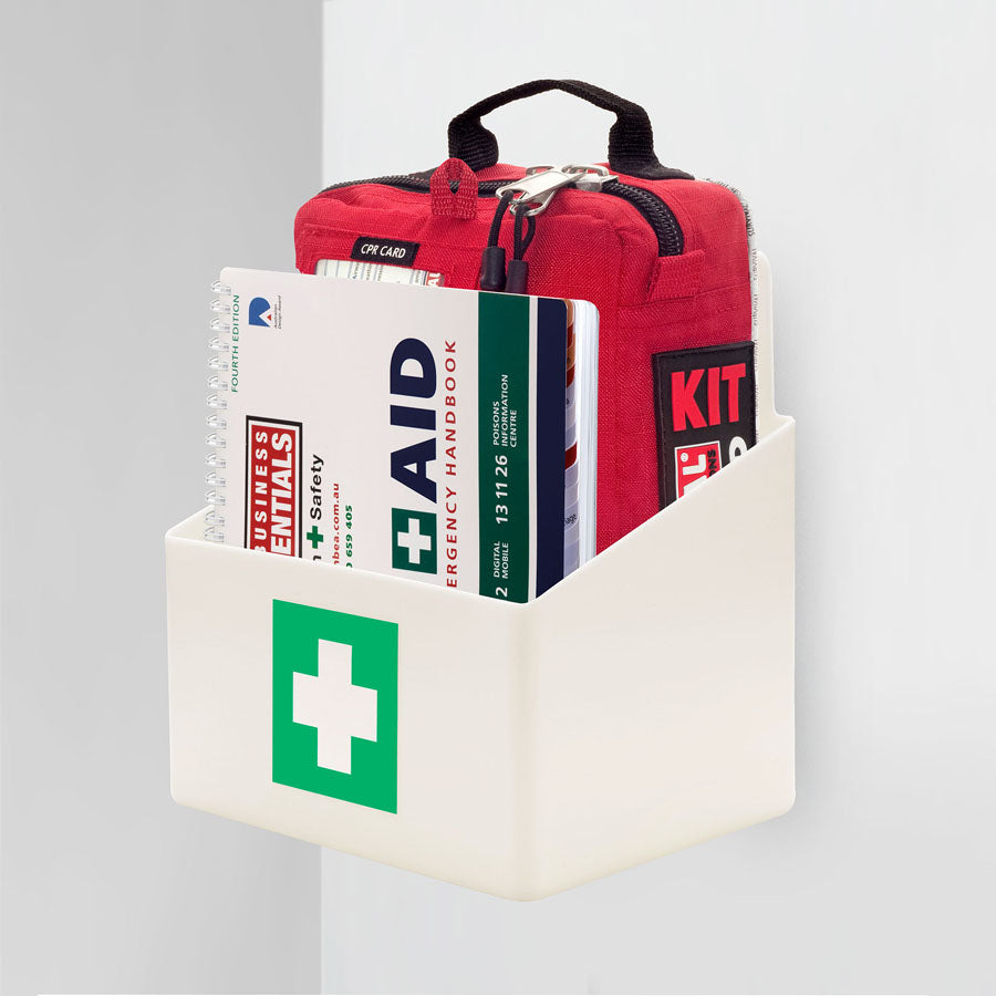 Workplace case mounted in the white wall bracket with the First Aid Emergency Handbook