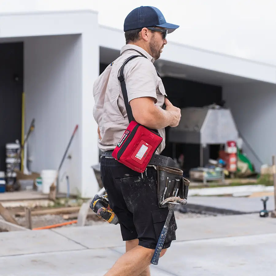 Worker on a building site wearing the red Grab and Go bag on a waist strap